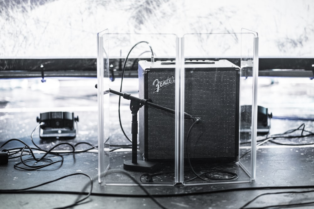 black Fender guitar amplifier in clear acrylic organizer