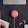 flat lay photography of coral Google Home Mini on black surface beside Apple AirPods