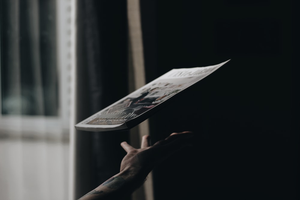 person throwing up labeled book