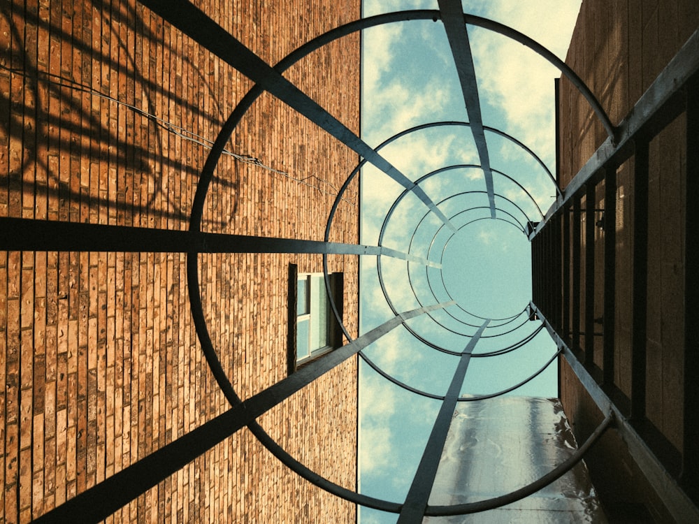 worm's eyeview photo of round metal building ladder