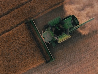 green farming equipment on brown field