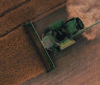 green farming equipment on brown field