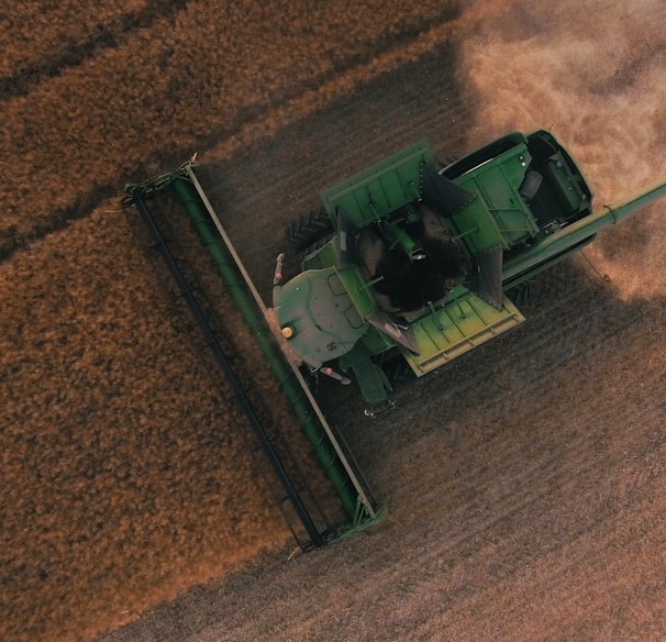 green farming equipment on brown field