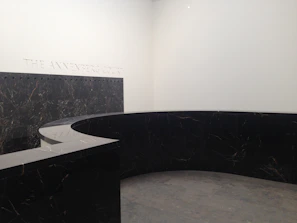 Large-format travertine slab installed as a sleek commercial lobby wall under soft lighting