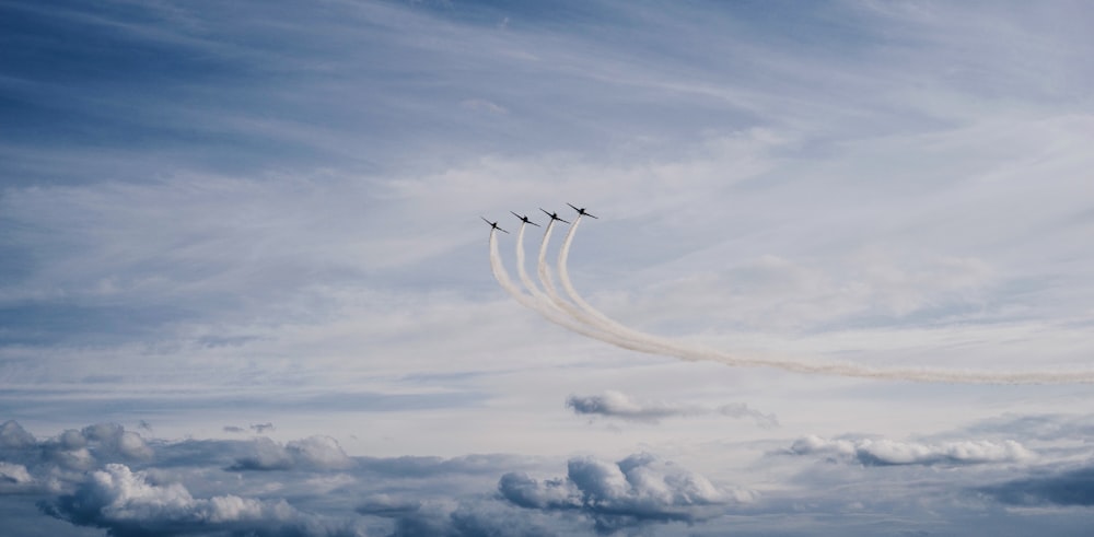 four jet contrails during daytime