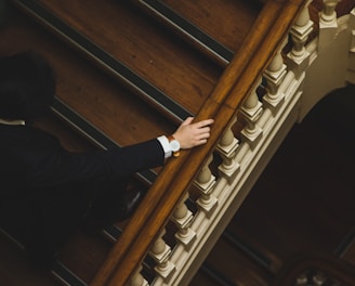 man climbing up the wooden stairs