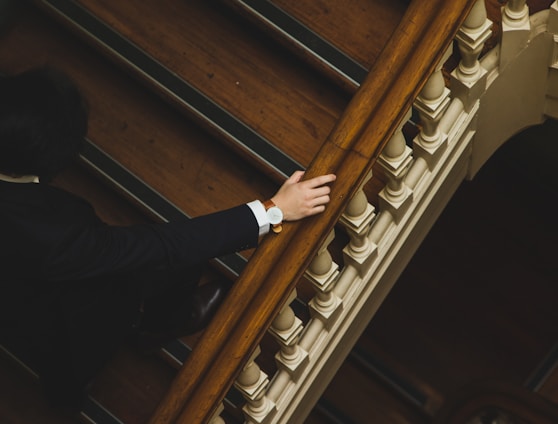 man climbing up the wooden stairs