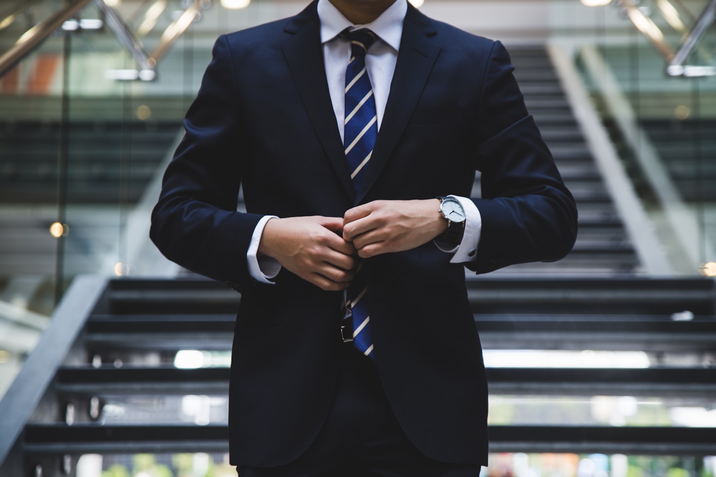 A man standing in formal attire.