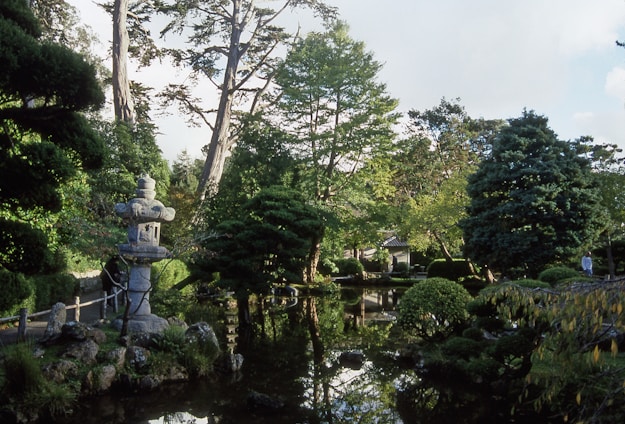 A peaceful Japanese garden with koi pond and stone lanterns surrounding the home.