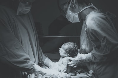 greyscale photo of medical operation birth google meet background