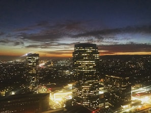 A dramatic cityscape at dusk with glowing futuristic elements integrated seamlessly.