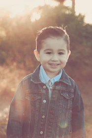 A young boy smiling after his haircut at home.