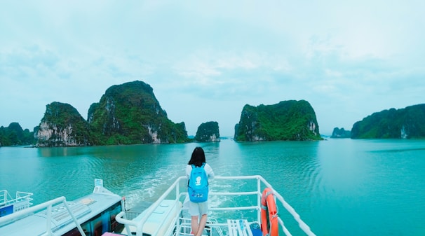 A peaceful moment on a boat, with a solo traveler gazing out at the vast blue sea around Nusa Penida.