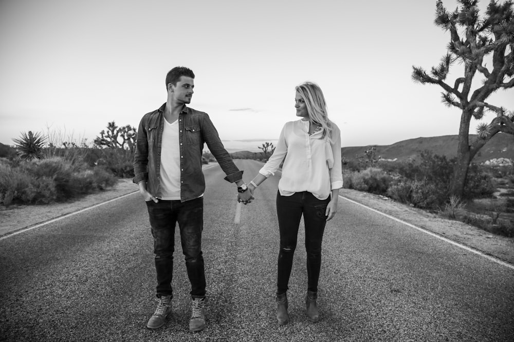 woman and man standing on concrete road