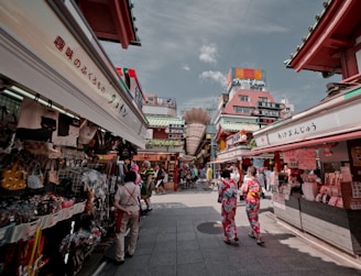 two women walking between buildings