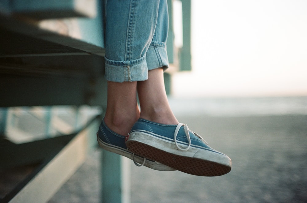 low angle photo of pair of blue-and-white Vans Authentics