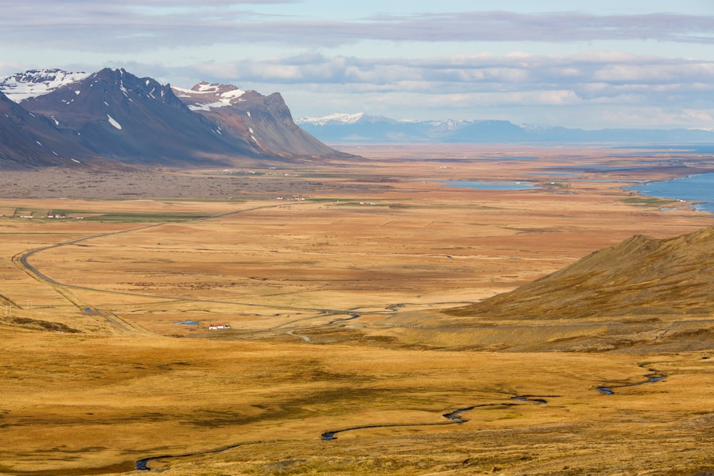 aerial photography of brown terrain with gray cloudy skies