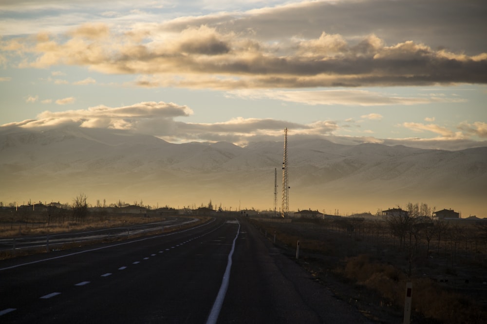 winding road under cumulus clouds