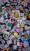 Custom stickers and labels arranged artistically on a dark background with soft lighting.