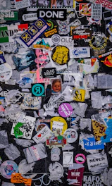 A collection of vinyl decals in vivid colors arranged artistically on a dark surface.
