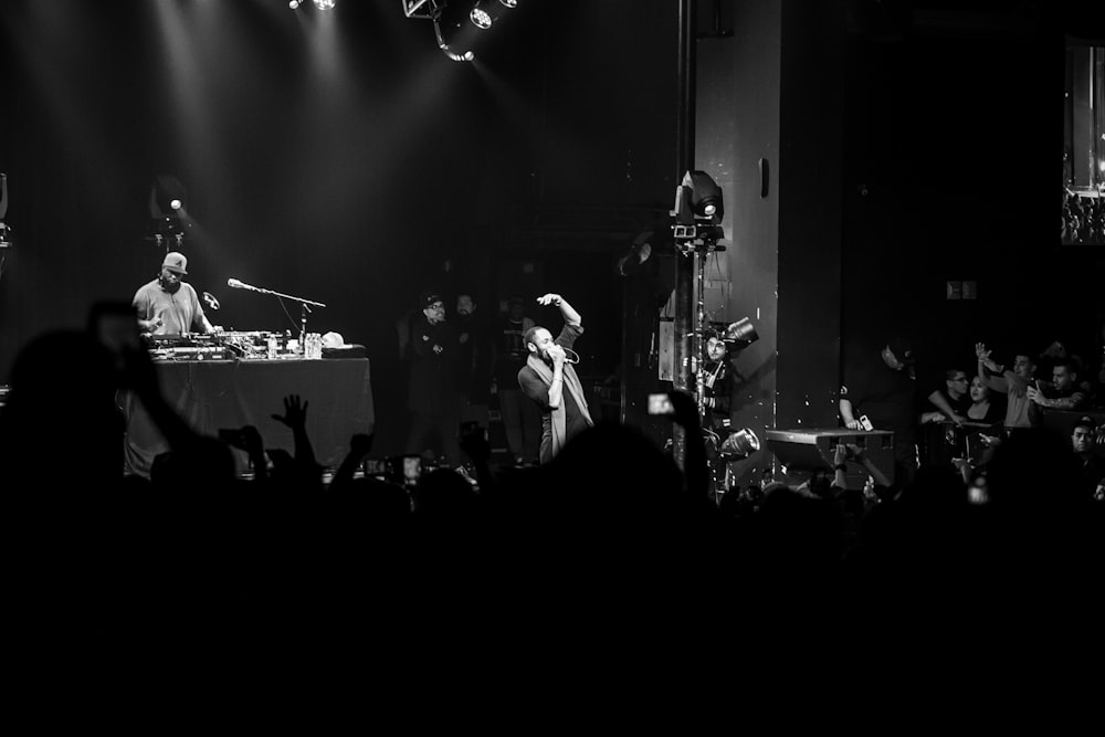 grayscale photo of a concert on the stage