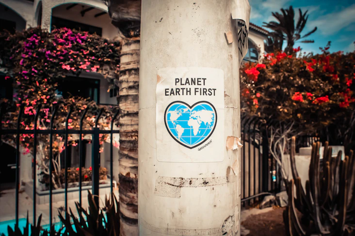 An environmental campaign sticker, illustrating the environmental impact point on this page