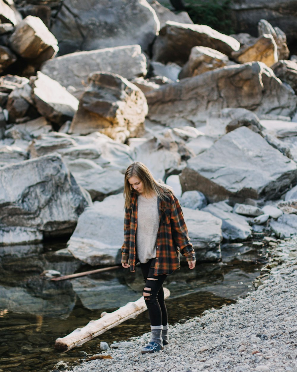 woman walking beside body of water