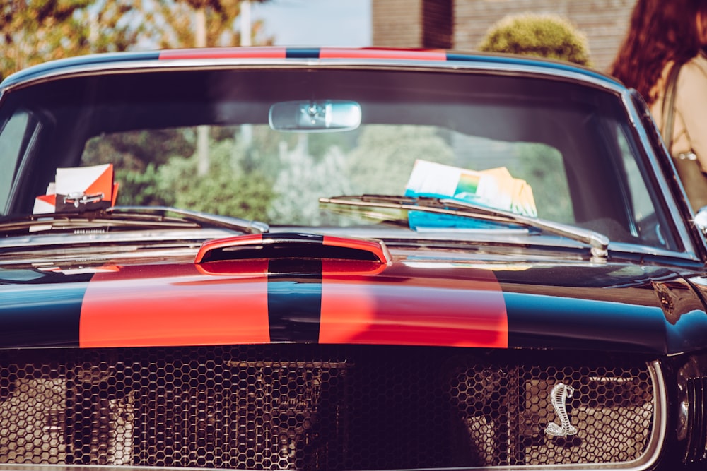 focus photo of red and black car