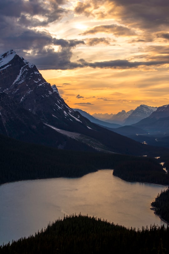 photo of lake near mountain at golden hour in Peyto Lake Canada