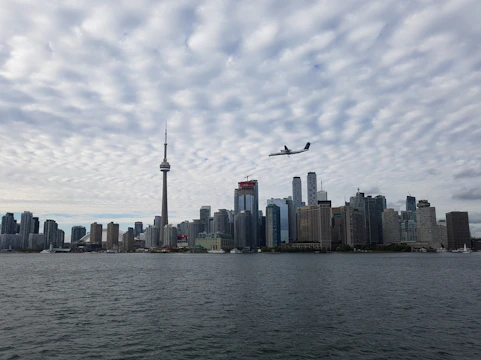 Chicago skyline with a plane soaring above Lake Michigan.
