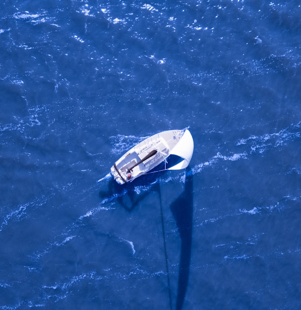 aerial view of boat sailing on blue ocean