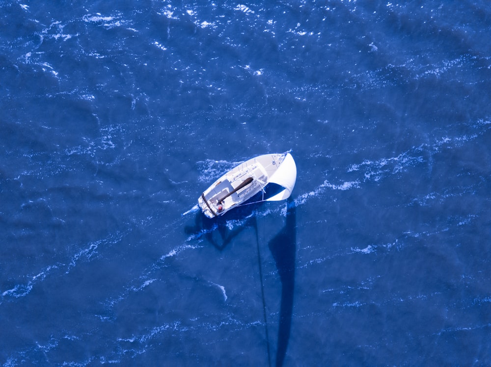 aerial view of boat sailing on blue ocean