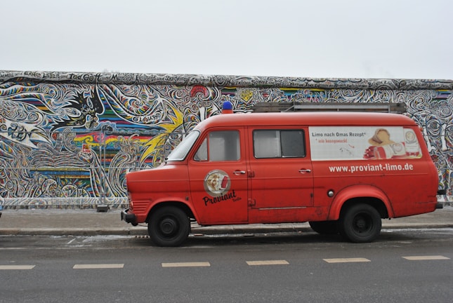 A sleek van fully wrapped with vibrant, custom vehicle lettering displaying the Schicknick logo.