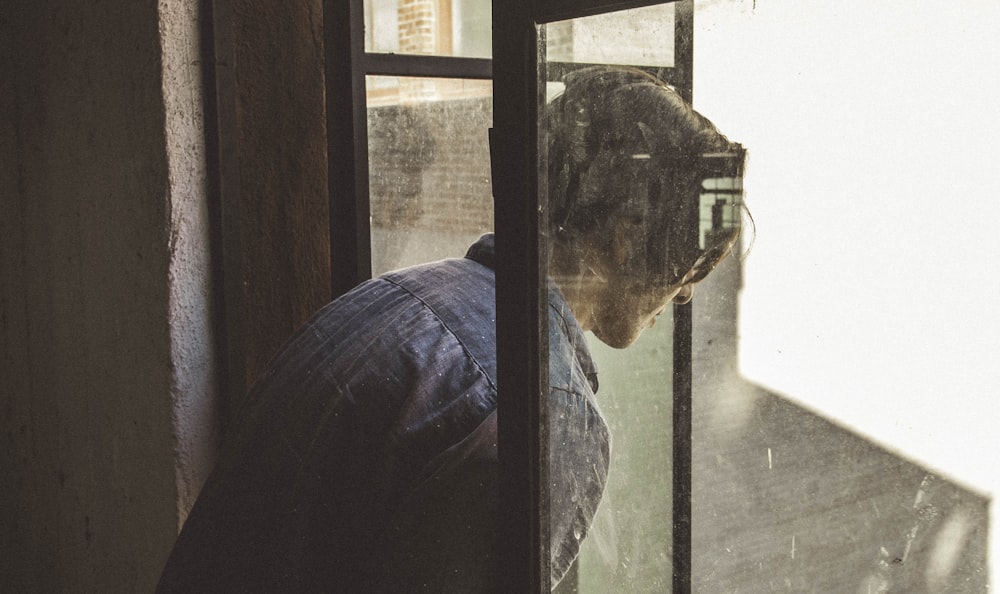 man staring on window