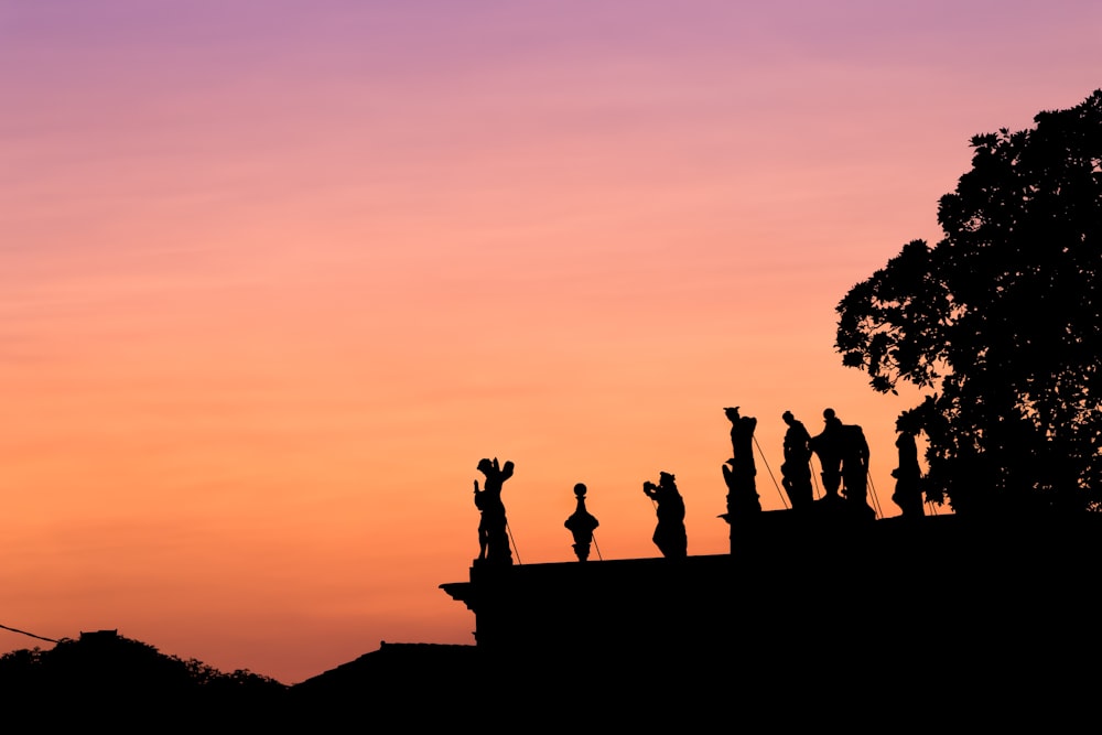 silhouette of people on top of mountain