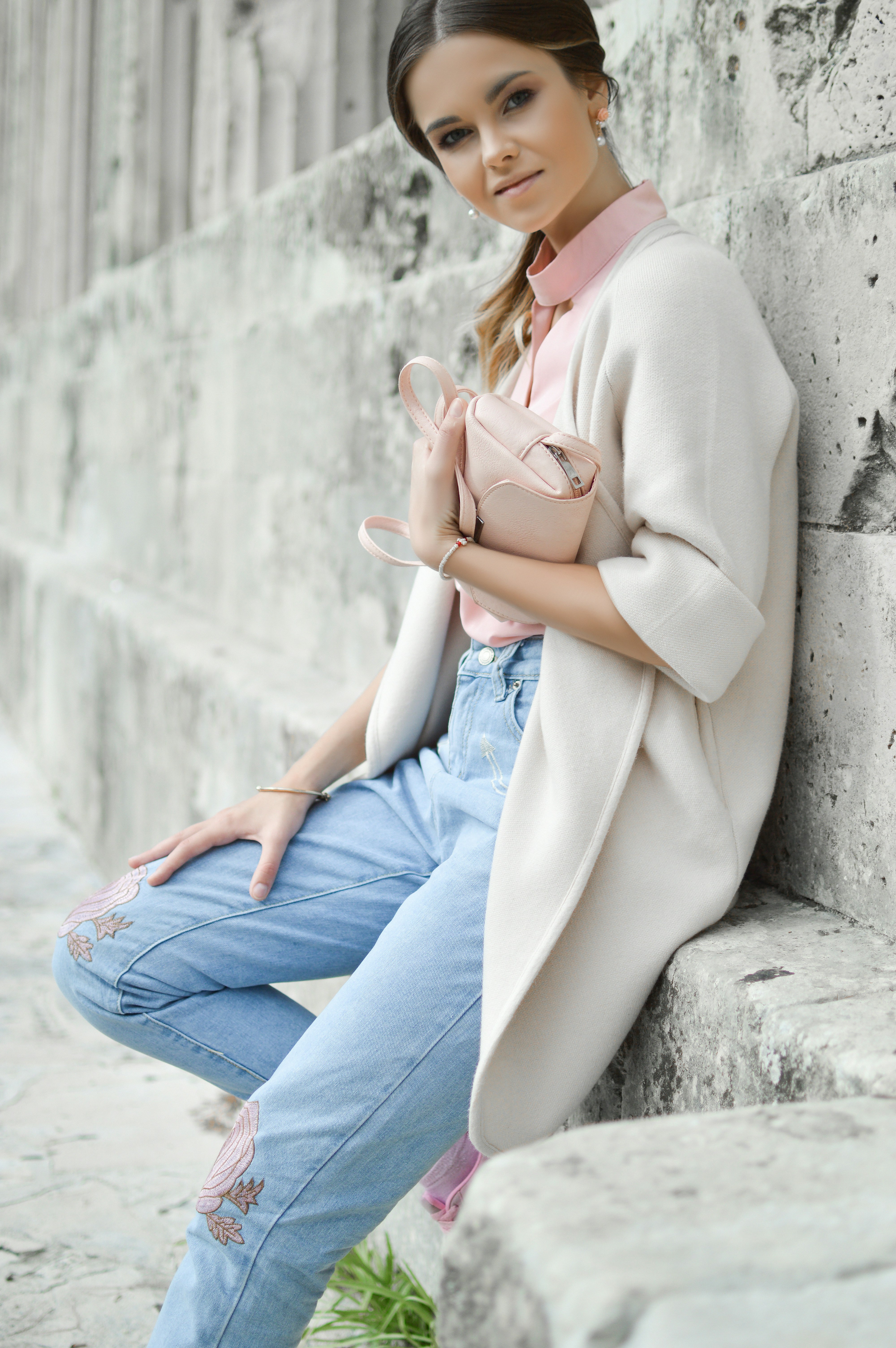 woman sitting on wall during during daytime