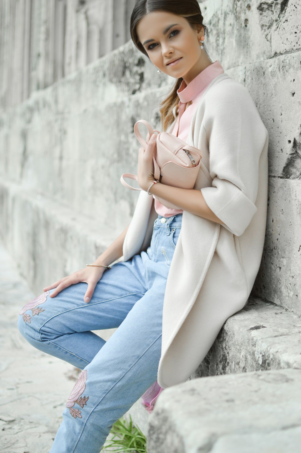 woman sitting on wall during during daytime