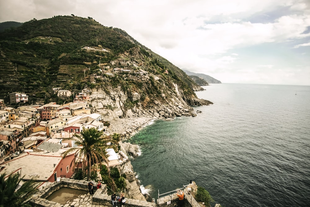 town beside body of water and hill during daytime