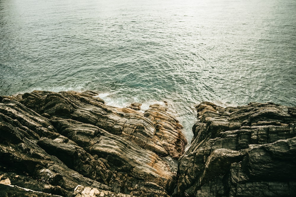 rock near body of water at daytime