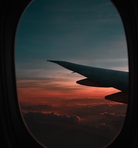 window view of airplane during golden hour