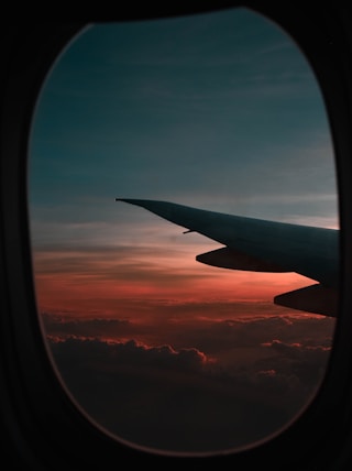 window view of airplane during golden hour