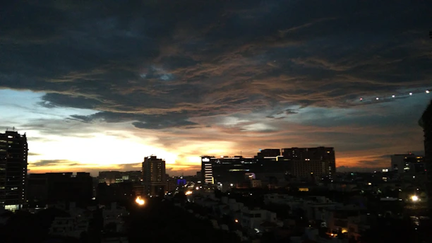 A vibrant cityscape of Xalapa at sunset with lively streets and colorful buildings.
