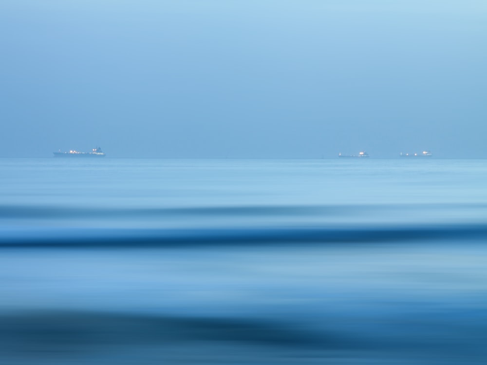 three boats on body of water