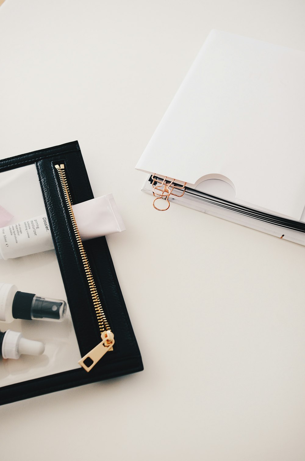 white folder beside bottles