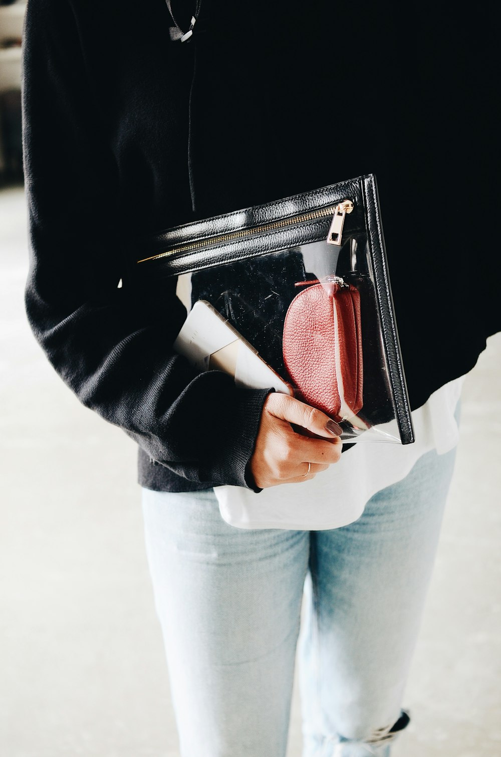 person holding pouch bag