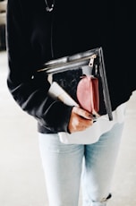 person holding pouch bag