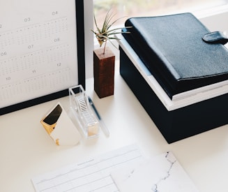 books and calendar on white table