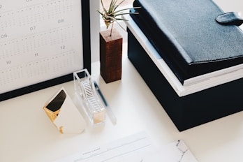 books and calendar on white table