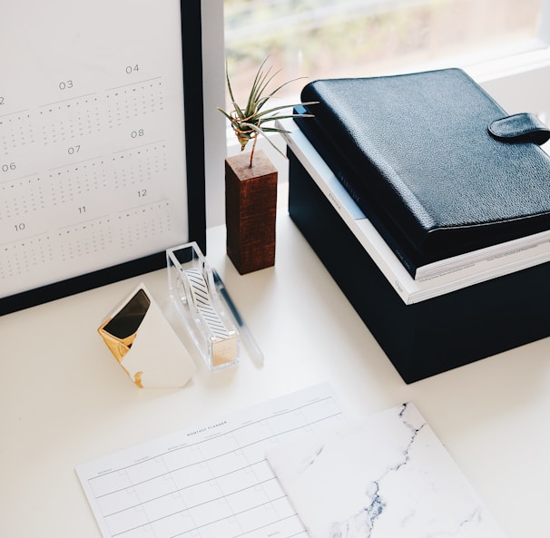 books and calendar on white table