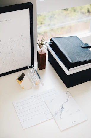 Functional 3D printed desk organizers arranged neatly on a workspace with natural light